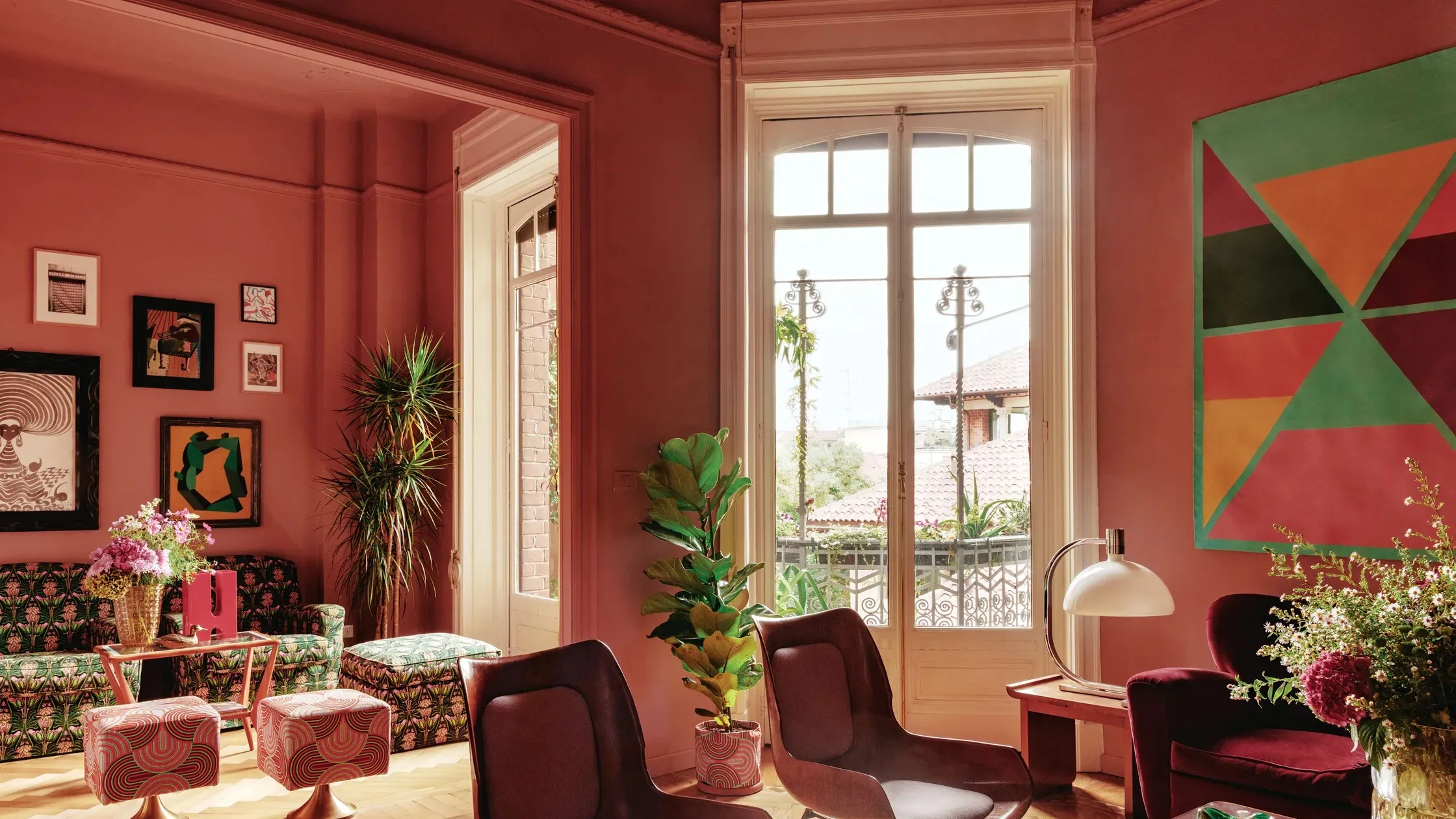 A real living room with sunlight hitting a newly painted wall, showing a subtle low-sheen finish and a simple sofa and rug
