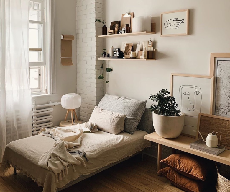 A small bedroom with a single window and light neutral walls, showing how daylight falls across the paint and changes from morning to afternoon